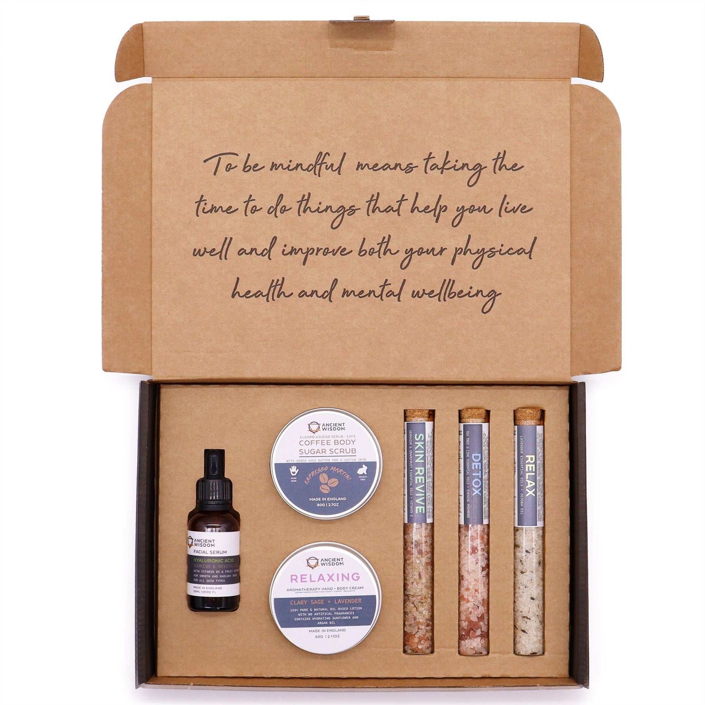 Mindful Moments Self Care Kit featuring body scrub, body cream, bath salts, and hyaluronic acid serum for relaxation and rejuvenation.