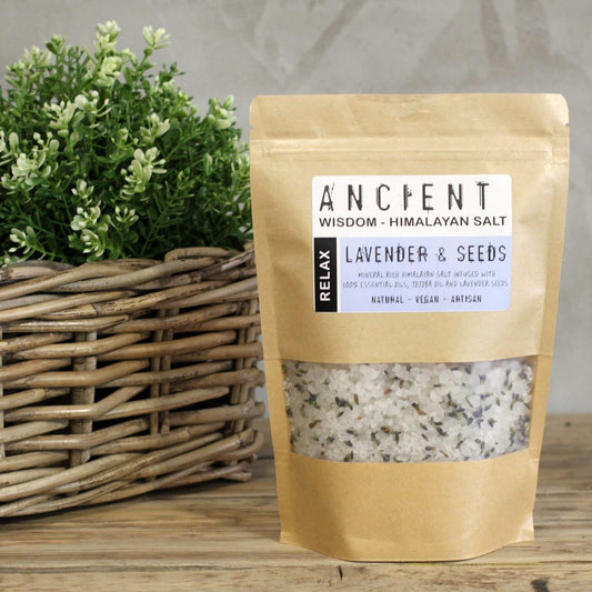 Himalayan Bath Salt Blend 500g package with calming lavender, displayed on a wooden surface next to a wicker basket with greenery.