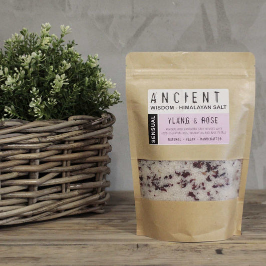Himalayan bath salt blend in kraft packaging with plant background.