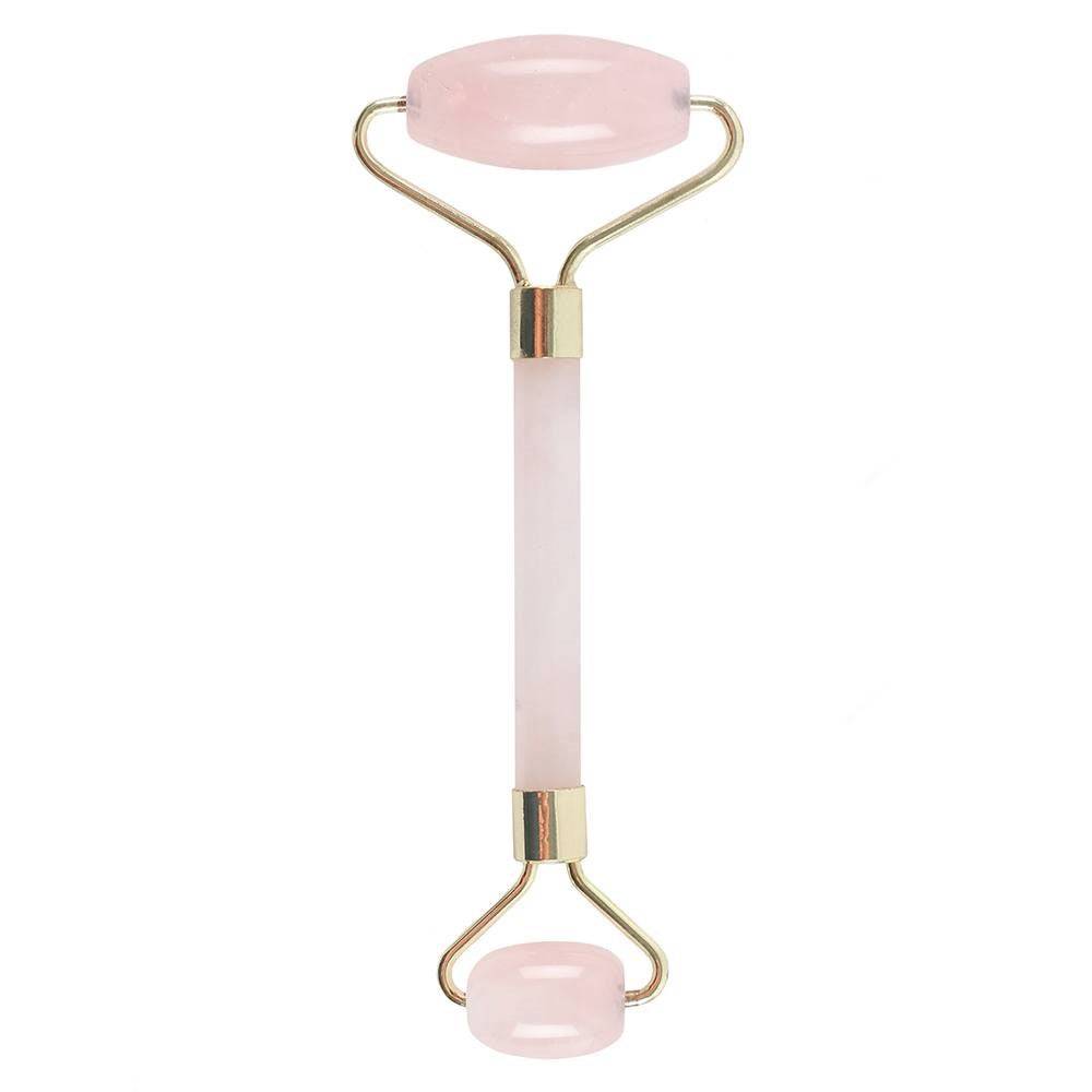 Rose quartz gemstone face roller for skincare and relaxation.
