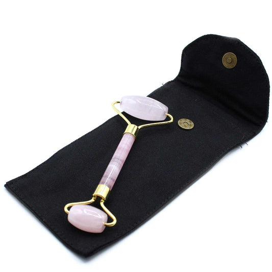 Rose quartz gemstone face roller for skincare and relaxation.