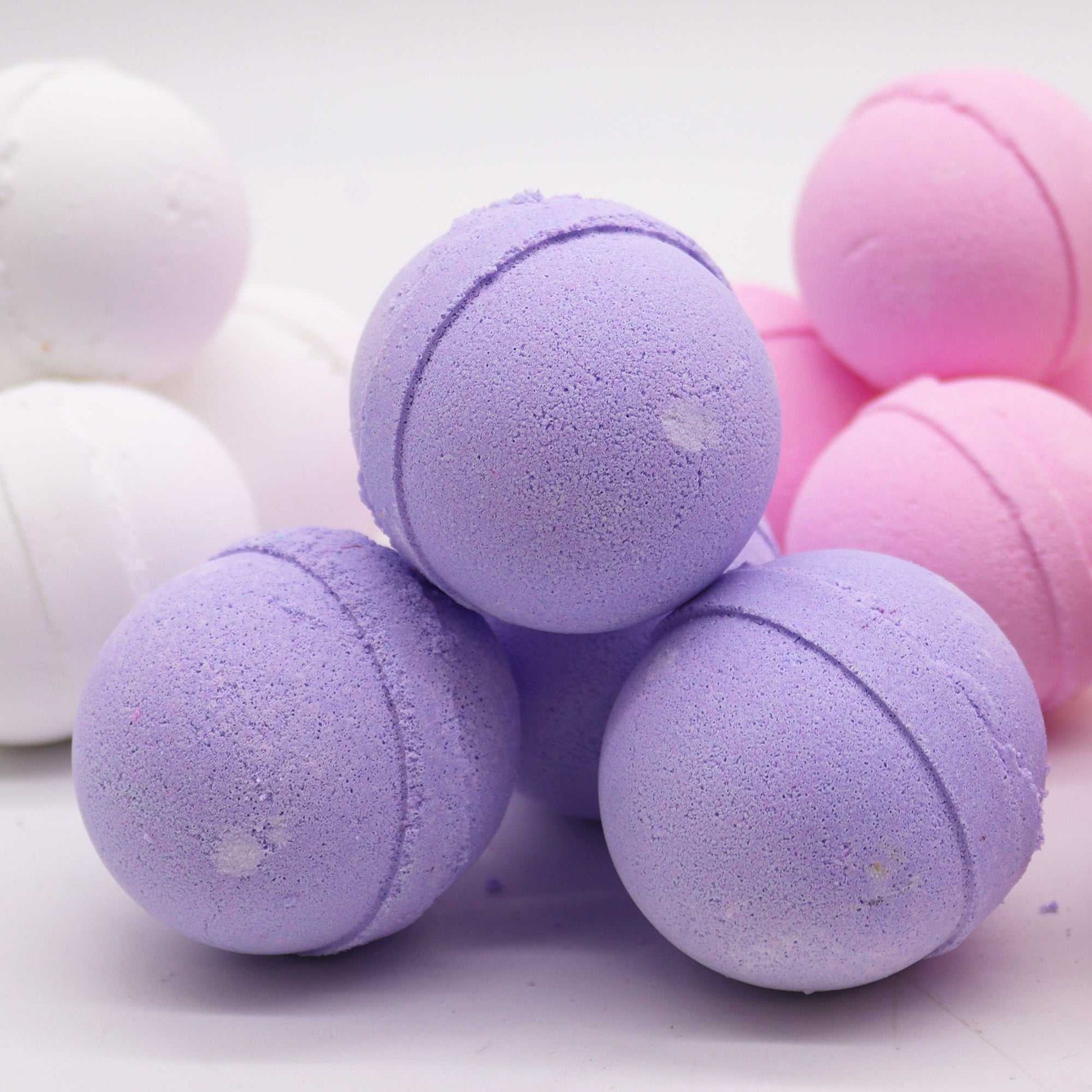 Essential oil bath bomb in clary sage and juniper, purple and spherical, perfect for relaxing baths.