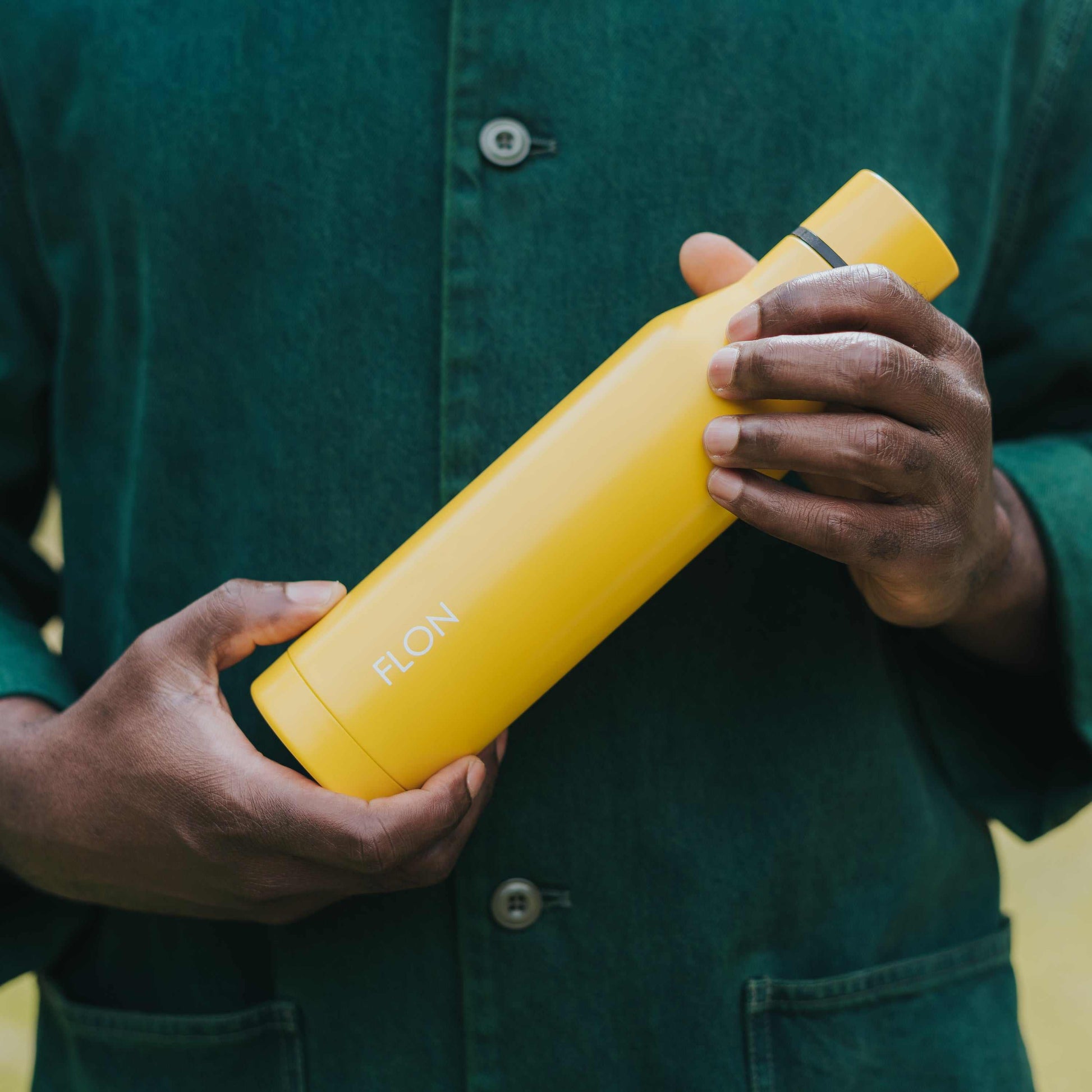 FLON Insulated Water Bottle 500ml with matte finish held outdoors.