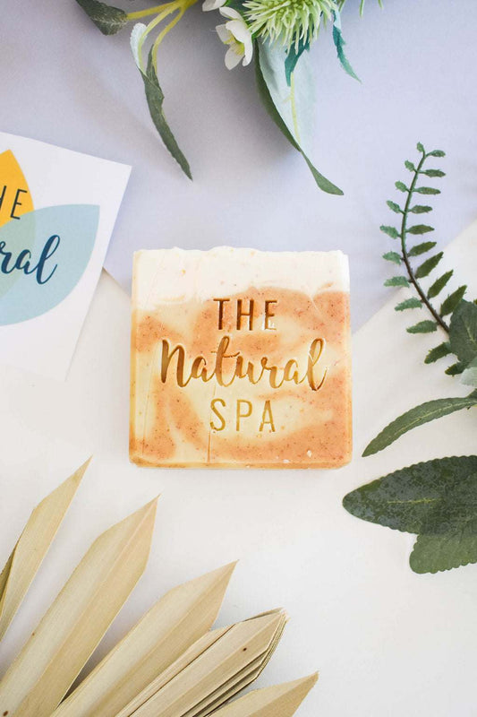 Natural Spa Eves Garden Soap Bar with lavender, lemongrass, and pine scent, displayed with greenery.