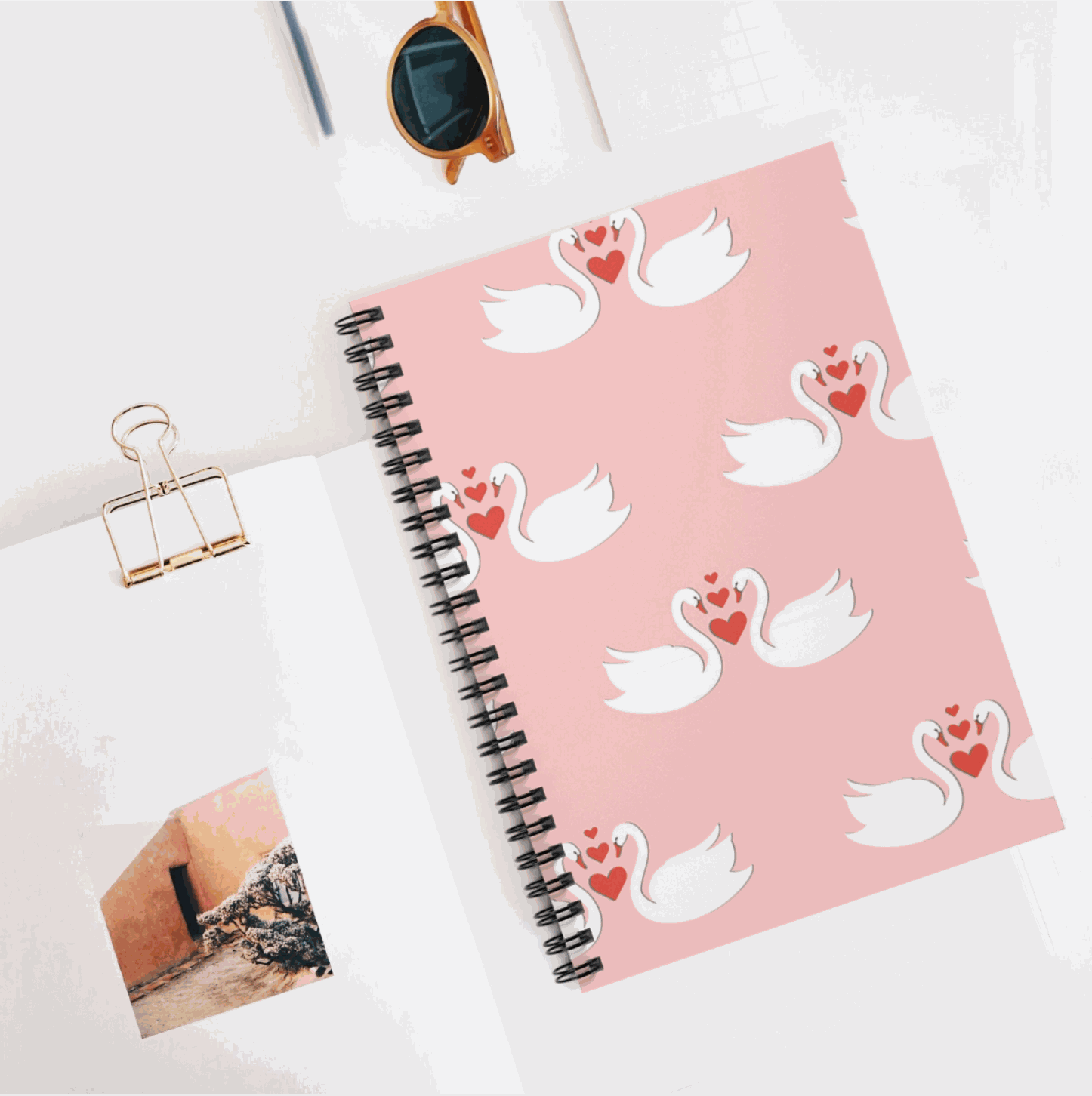 Swans & Hearts lined notebook with spiral binding, featuring swan and heart design on pink cover.